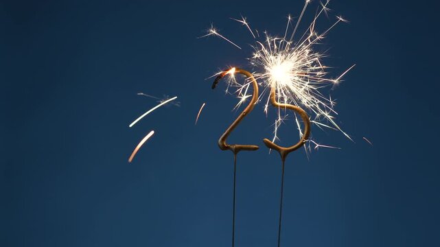 25 years celebration festive background made with Bengal fires in the form of number Twenty-five.