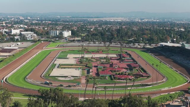 Telephoto aerial reverse pullback shot of the racetrack at Santa Anita Park in Los Angeles, California. 4K
