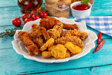 Golden crispy fried chicken mix - wings, drumsticks, nuggets and strips