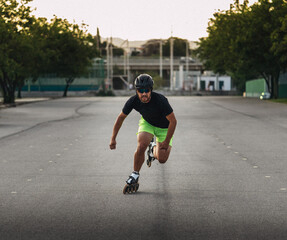 Fototapeta premium Man inline skating outdoors, moving with speed and fitness