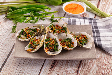 Gournet grilled oysters with onion and peanut