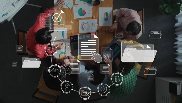 A diverse team gathers around a table for a business planning meeting, utilizing digital tools and icons to enhance workflow and data management in a collaborative workspace. Raster
