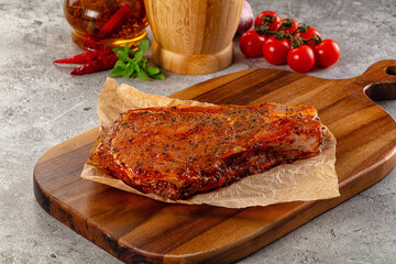 Raw marinated pork loin steak