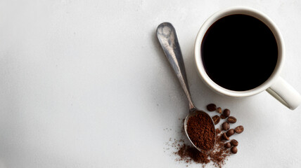 Cup of coffee with beans and ground coffee on white background.