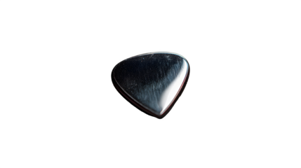 A single guitar pick isolated on a black background with visible scratches and reflections on its surface