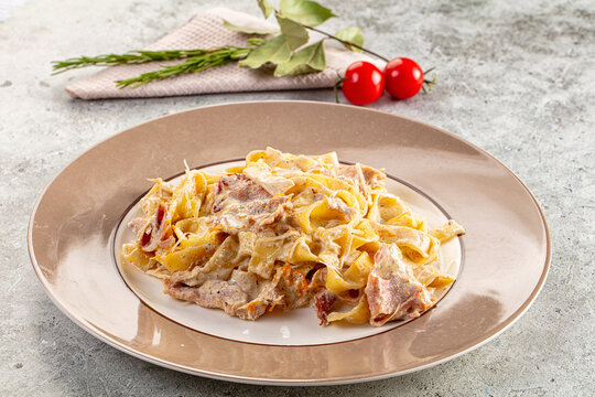 Italian pasta fettuccine with prosciutto