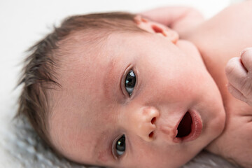 Newborn baby opening mouth discovering new world