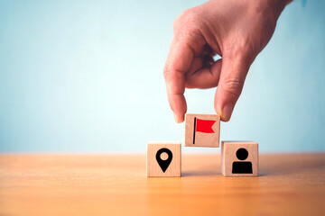 Goal Setting and Strategic Leadership Concept with Hand Placing Red Flag Icon Above Location and Person Blocks