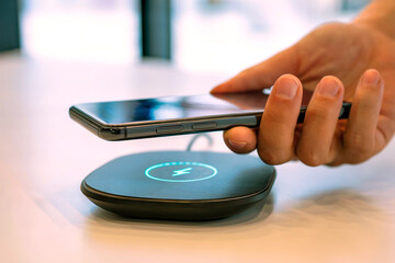 Smartphone Hovering Above Wireless Charging Pad in Modern Tech Setting