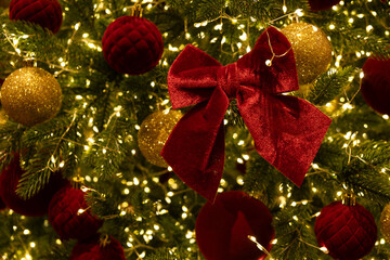 Christmas tree decorated with red and gold ornaments. 