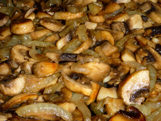 Sautéed Mushrooms and Onions Cooking in a Frying Pan