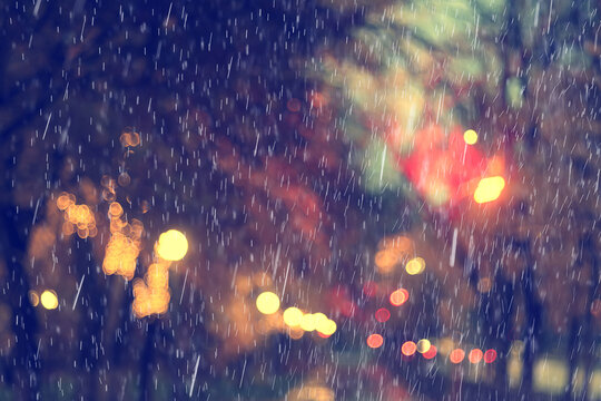 Background photo of rain in an evening park, drops moving in blur, weather changing