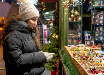 Girl Looking At Christmas Ornaments On A Stall At A Fair
