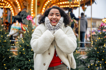 indian woman standing by christmas carousel at senate square helsinki