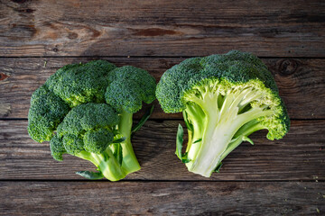 Fresh raw broccoli on wooden background. Top view