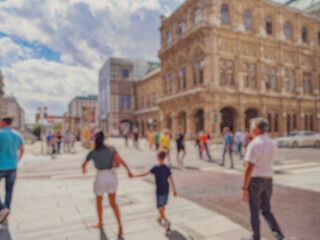 Crowd of anonymous people walking on busy city street