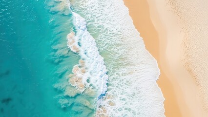 Stunning aerial view of turquoise ocean waves meeting golden sandy beach