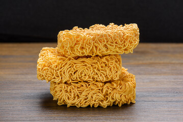 Closeup view of dried instant noodles on wooden table