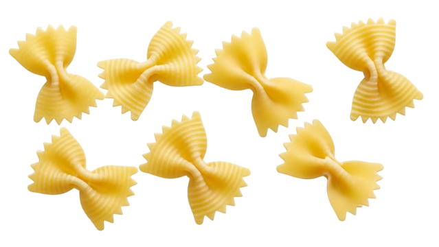 Six bow tie pasta shapes on black background