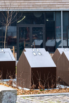 Neat rows of urban containers in Copenhagen show recycling and waste management with minimalism and eco design, communicating environment, sustainability and ongoing climate action