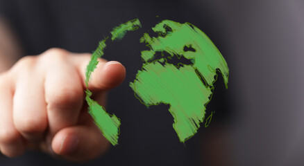 A person's hand interacts with a glowing green digital Earth globe, symbolizing global environmental protection, sustainability, and interconnec