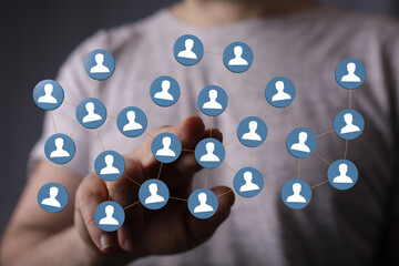 Visual representation of a social network, teamwork, or interconnectedness, with a human hand interacting with