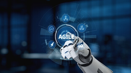 A futuristic robotic hand interacts with a digital interface featuring symbols of agility and innovation, highlighting modern technology in a sleek workspace setting. Synapse