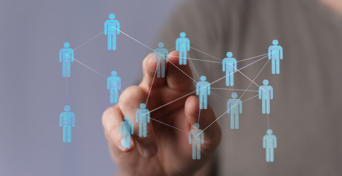 Hand interacting with digital network of people, representing connectivity, networking, and social media.