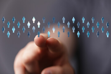 Concept of connection, choice, and digital interaction.  A finger points at a selection of people icons, representing targets and networks.