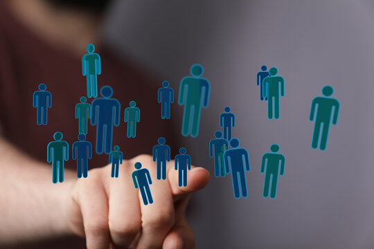 Hand pointing at a network of people icons, representing social connections, teamwork, and unity in a community