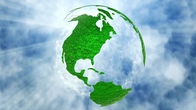 Rotating green grass planet Earth against a blue sky with clouds representing ecology, nature conservation, and global environmental sustainability