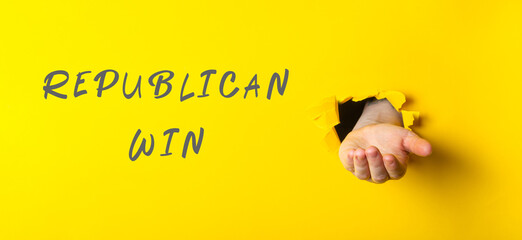 Hand emerging from yellow background with text representing victory and celebration concept