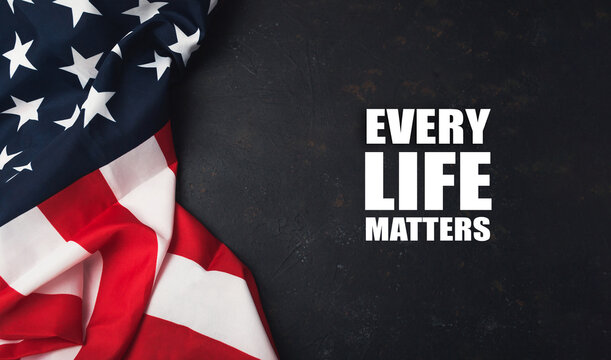 American flag draped on dark surface with powerful message about equality and unity