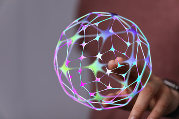 An abstract, glowing sphere is held in a person's hand, symbolizing technology, networks, and the future. Perfect for futuristic conc