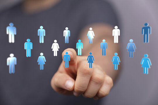 Hand pointing at digital people icons representing network, teamwork, business and connection. Social media community and technology concepts.