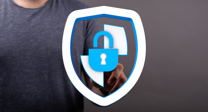Concept of cybersecurity. Hand touching a virtual shield with a padlock, representing data protection and online safety. Ideal for te
