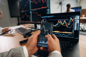 Close up view of hands of business men that are working with stock market exchange