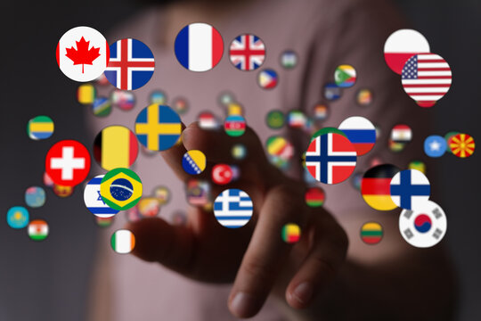 A visual representation of global unity and communication. Hand touching international flags, symbolizing interconnectedness, diplomacy and glob