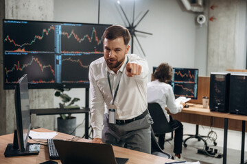 Pointing the finger at you, camera. Two male exchange workers are in the office together