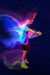 Fototapeta premium Young athlete in action preparing to hit a ball during an energetic sports session