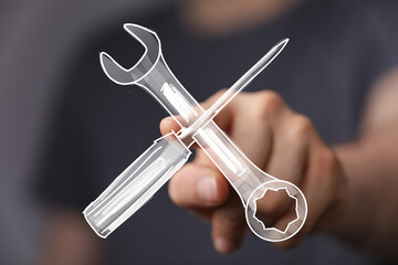 High-quality image of a hand pointing at crossed wrench and screwdriver. Ideal for repair,...