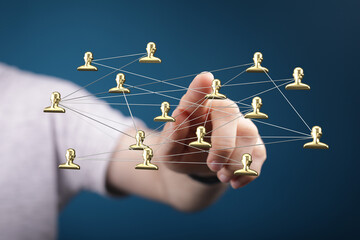 A conceptual image of a hand touching a network of connected people icons, representing communication, connections, and teamwork.