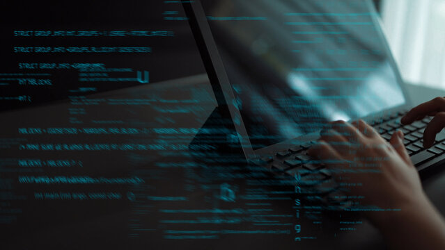 A close-up view of a person hands typing on a laptop, featuring an abstract overlay of glowing code that symbolizes technology, coding, and digital innovation. Xenic