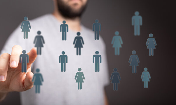 Man touching digital human icons representing networking, teamwork, and social interaction in the metaverse. - Powered by Adobe