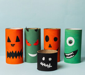 Colorful Halloween-themed paper crafts with spooky faces for autumn festivities and decoration