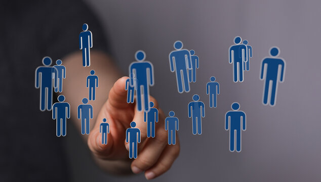 Hand pointing towards digital human icons representing connection and community, symbolizing social media, onli