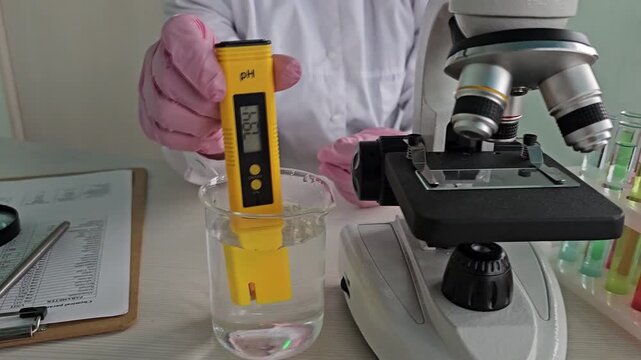 Laboratory testing of water pH using a digital meter and microscope setup