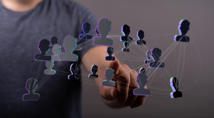 Visualize connection, teamwork, communication, and digital networking with this image. A hand interacts with interconnected digital people. Repr