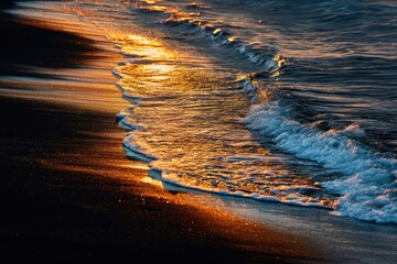 Golden Hour Waves: Sunlight Sparkles on Ocean Shore
