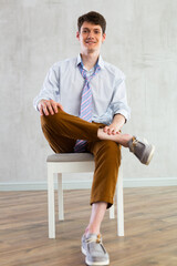 Young guy office worker doing exercises on chair